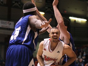 University of Winnipeg Wesmen forward Brayden Duff drives between Keyano College Huskies post Demaine Nelson (left) and Huskies player Jesse Denscombe during Wesmen Classic basketball action at the University of Winnipeg's Duckworth Centre on Wed., Dec. 28, 2011. (JASON HALSTEAD/WINNIPEG SUN)