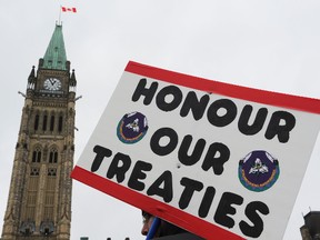 A person holds a sign during a First Nations rally at Parliament Hill in Ottawa Jan 24, 2012. (ANDRE FORGET/QMI AGENCY)