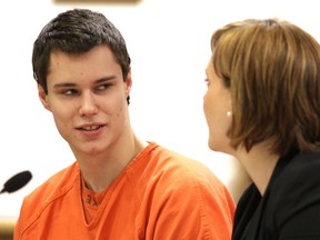 Colton Harris-Moore (L), the Barefoot Bandit, talks with one of his lawyers at his sentencing in Island Superior Court in Coupeville, Washington in this December 16, 2011 file photograph. (REUTERS/Marcus Donner/Files)