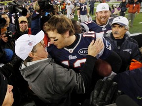 New England Patriots head coach Bill Belichick embraces quarterback Tom Brady after they defeated the Baltimore Ravens in the NFL AFC Championship game last Sunday in Foxborough. (REUTERS)