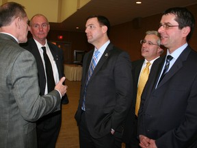 Ontario Progressive Conservative leader Tim Hudak, centre, listens as Northern College president Fred Gibbons, left, makes a point following Hudak's speech at a Timmins Chamber of Commerce luncheon on Jan. 25, 2012. (RON GRECH/QMI Agency)