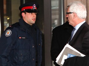 Toronto Police Const. Michael Adams talks to his lawyer, Gary Clewley, after testifying Friday at a coroner’s inquest into the 2010 fatal arrest of 18-year-old Junior Manon. (CHRIS DOUCETTE/Toronto Sun)