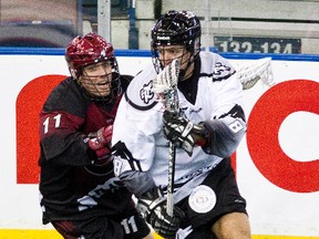 Edmonton Rush forward Tom Johnson is pursued by Colorado Mammoth opponent John Gallant in a 13-12 loss at Rexall Place to open the season last weekend. (Codie McLachlan, Edmonton Sun)