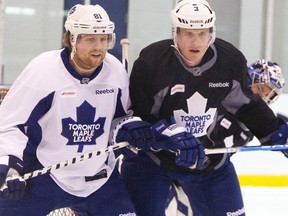 Phil Kessel and Dion Phaneuf jostle in front of the net. (JACK BOLAND/QMI Agency)