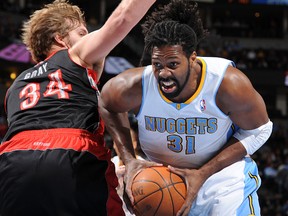 Nene of the Nuggets drives to the basket against Aaron Gray of the Toronto Raptors in Denver on Friday night. (Getty Images)