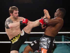 Antonio McKee blocks a kick delivered by Brian Cobb in the co-main event at MFC 32: Bitter Rivals on Friday at the Mayfield Inn. (Amber Bracken, Edmoton Sun)