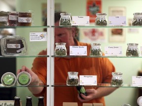 Employee Stephen Young restocks the shelves behind bullet-proof glass at Northwest Patient Resource Center in Seattle, Washington January 27, 2012. (REUTERS/Cliff DesPeaux)