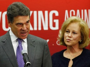 Texas Governor Rick Perry stands next to his wife Anita as he announces he is dropping his run for the Republican U.S. presidential nomination during a news conference in Charleston, South Carolina January 19, 2012. (REUTERS/Eric Thayer)