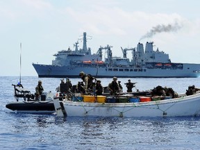 A photo handed out by Britain's Ministry of Defence shows a Royal marines team boarding a suspected pirate vessel 420 nautical miles from the Seychelles and 350 nautical miles from the Somali coast in the Indian Ocean in this photo taken on November 28. (REUTERS/Handout/Royal Navy/LA Dave Jenkins)