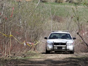 RCMP and Edmonton police officers continues their search of the river valley near the low level and James Macdonald bridges in Edmonton, Alberta on May 11, 2011.  Project KARE is the RCMP-led task force launched in 2003 to investigate the slayings and disappearances of locals living high-risk lifestyles.      PERRY MAH/EDMONTON SUN