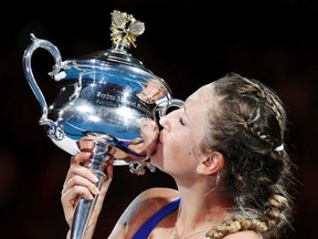 Victoria Azarenka kisses her trophy after defeating Maria Sharapova for the Australian Open title in Melbourne, Australia, Jan. 28, 2012. (TIM WIMBORNE/Reuters)