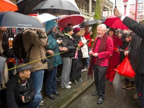 Interim federal Liberal leader Bob Rae jokes with spectators while taking part in the Lunar New Years Parade in Vancouver, B.C., Jan. 29, 2012. (ANDY CLARK/Reuters)