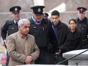 Mohammad Shafia arrives for his first degree murder trial at the Frontenac County Court house in Kingston. He along with his wife Tooba Mohammad Yahya and their son Hamed (rear) are each charged with four counts of first degree murder in the deaths of four other family members. (IAN MACALPINE/QMI Agency)