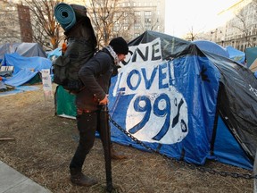 An Occupy DC demonstrator packs up his camping gear, in compliance with new restrictions, at McPherson Square in Washington January 30, 2012. REUTERS/Kevin Lamarque