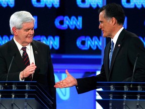 Republican presidential candidate former Speaker of the House Newt Gingrich (L) reaches to shake hands with Massachusetts Governor Mitt Romney after the Republican presidential candidates debate in Jacksonville, Florida January 26, 2012.  REUTERS/Scott Audette (UNITED STATES  - Tags: POLITICS ELECTIONS)