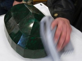 A worker polishes the world's largest emerald at Western Star Auction House in Kelowna, British Columbia on January 26, 2012. (REUTERS/Andy Clark)