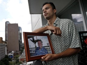 Alejandro Martinez, partner of Jim Hearst, holds a photo of the 50-year-old who suffered a fatal heart attack in 2009. (QMI Agency)