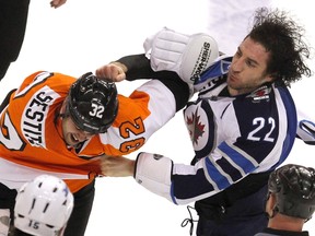 Winnipeg Jets winger Chris Thorburn (22) trades punches with Philadelphia Flyers winger Tom Sestito (32) during the third period, Tuesday in Philadelphia. In addition to the fight, Thorburn scored his first goal since last March. (TIM SHAFFER/Reuters)