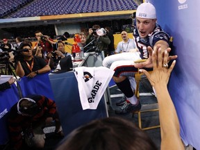 New England Patriots' tight end Rob Gronkowski slaps hands with a reporter during Tuesday's Super Bowl media day. The receiver said little about his high ankle sprain. (REUTERS)