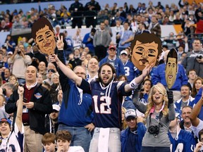 New England Patriots fans Nick Lowery (left) and Hanna Love watch from the stands during Super Bowl media day, Tuesday, in Indianapolis. Tickets were $35 a pop. (REUTERS)