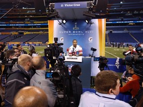 New York Giants receiver Victor Cruz draws a huge crowd of media during Super Bowl week in Indianapolis. (REUTERS)