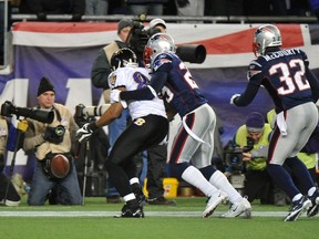 Baltimore Ravens wide receiver Lee Evans (left) can't hold on to what would have been a touchdown pass under pressure from New England Patriots free safety Sterling Moore in the final minute of last Sunday's AFC Championship. (REUTERS)