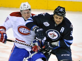 Defenceman Dustin Byfuglien (right) could be back in the lineup Thursday night after missing 16 games with a knee injury. His return would mean a lot to the Jets. (FRED GREENSLADE/Reuters files)