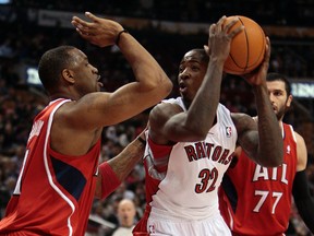 Ed Davis of the Toronto Raptors looks past Tracy McGrady of the Atlanta Hawks in the first half Tuesday night at the ACC. (DAVE ABEL/Toronto Sun)