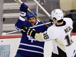 Penguins’ James Neal (right) cross checks Maple Leafs’ Mike Brown during the first period on Tuesday night in Pittsburgh. (Reuters)