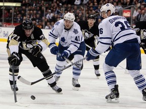 Maple Leafs forward Nikolai Kulemin and defenceman Carl Gunnarsson chase down Penguins star Evgeni Malkin on Wednesday night at the Air Canada Centre. (Dave Abel/Toronto Sun)
