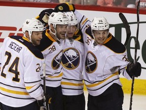 Sabres teammates Robyn Regehr (left to right), Paul Gaustad, Jordan Leopold and Patrick Kaleta celebrate their victory against the Candadiens at the Bell Centre in Montreal, Que., Jan. 31, 2012. (CHRISTINNE MUSCHI/Reuters)