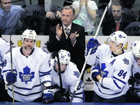 Ron Wilson applauds during a tribute to Sgt. Cameron Laidlaw and his wife, Master Cpl. Nicole Laidlaw, during Wednesday night’s game against Pittsburgh at the Air Canada Centre. (Dave Abel/Toronto Sun)