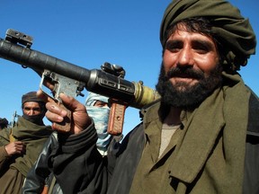 A Taliban militant poses for a picture after joining the Afghan government's reconciliation and reintegration program, in Herat January 30, 2012. REUTERS/Mohammad Shoiab