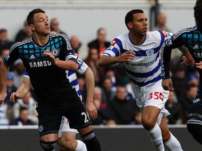 Queens Park Rangers' Anton Ferdinand (R) and Chelsea's John Terry run for the ball during their FA Cup soccer match at Loftus Road in London January 28, 2012.  (REUTERS/Eddie Keogh)