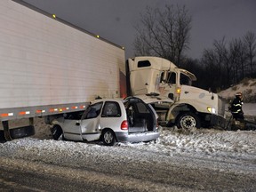 A man somehow escaped serious injury when his minivan was partially crushed under a transport truck south of Montreal on Wednesday morning. (ERIK PETERS/QMI AGENCY)