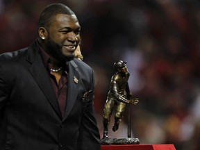 Boston Red Sox' David Ortiz stands with the Roberto Clemente Award he received before the Texas Rangers met the St. Louis Cardinals in Game 2 of MLB' World Series baseball championship in St. Louis, Missouri, Oct. 20, 2011.  (REUTERS/Ray Stubblebine)