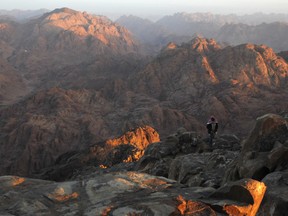 A Bedouin man walks to the peak of Mount Catherine, the highest mountain in Egypt, 2,629 m (8,625 ft), in Saint Katherine city, in Southern provinces of Sinai Peninsula in this October, 1, 2010 file photo. (REUTERS/Asmaa Waguih)