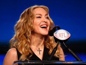 Recording artist Madonna reacts to a question during a news conference for her upcoming Super Bowl XLVI NFL football game halftime show in Indianapolis, Indiana February 2, 2012.  REUTERS/Joe Skipper