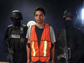 Jose Ramon Acosta Quintero (C), suspected of assaulting a Canadian woman at a hotel in Mazattlan, is presented to the media in Mexico January 28, 2012. (REUTERS/Stringer)