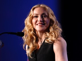 Recording artist Madonna takes part in a news conference for her upcoming Super Bowl XLVI NFL football game halftime show in Indianapolis, Indiana February 2, 2012.  REUTERS/Jeff Haynes