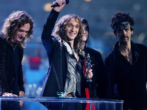 British rock group The Darkness, (L-R) Dan Hawkins, Justin Hawkins, Ed Graham and Frankie Poullain in a 2004 file photo. (Reuters/Stephen Hird)