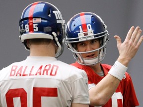 While chatting with Giants tight end Jake Ballard (left) at practice yesterday, quarterback Eli Manning gives the directions to a KFC in downtown Indianapolis.
