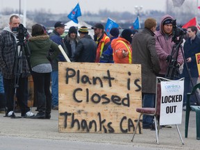 Locked out workers and media mill outside of Electro-Motive Canada in London, Ontario on Friday, Feb. 3, 2102. (DEREK RUTTAN/QMI AGENCY)