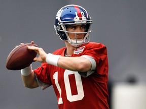 New York Giants quarterback Eli Manning throws a pass during practice for  Super Bowl XLVI in Indianapolis. (REUTERS)