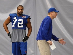 New York Giants defensive end Osi Umenyiora (72) listens to his position coach Robert Nunn during a Super Bowl practice this week in Indianapolis. (REUTERS)
