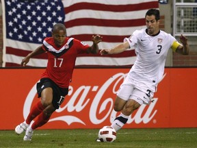 Carlos Bocanegra (R) of the U.S. takes control of the ball next to Canada's Simeon Jackson during the first half of their CONCACAF Gold Cup soccer match in Detroit, Michigan June 7, 2011.  (REUTERS/Rebecca Cook)