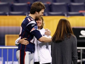 New England Patriots quarterback Tom Brady hugs his mother Galynn during a walk-through of the Lucas Oil Stadium before Super Bowl XLVI. (REUTERS)