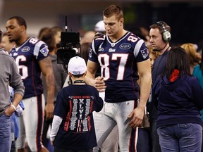 New England Patriots tight end Rob Gronkowski greets a young guest
 during a walk-through of the Lucas Oil Stadium before Sunday's Super Bowl. (REUTERS)