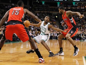 Boston Celtics E'Twaun Moore drives past Toronto Raptors Amir Johnson (left) and Gary Forbes during his team's lopsided victory Wednesday in Boston. (REUTERS