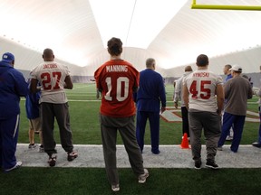 New York Giants quarterback Eli Manning (10) watches Saturday's practice for Super Bowl XLVI in Indianapolis. (REUTERS)